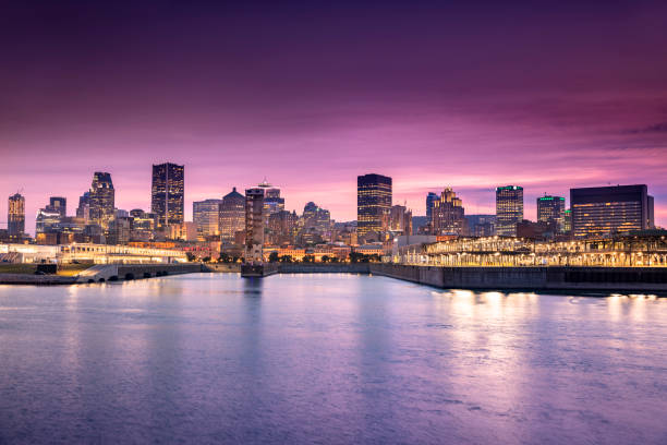 Downtown city skyline at night, showing St. Lawrence River, Montreal, Quebec, Canada