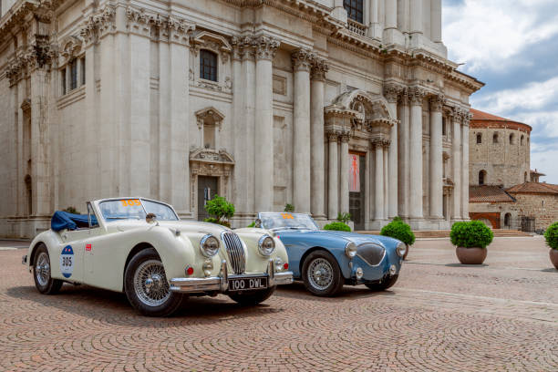 The historic Mille Miglia car race. Exhibition of  historical vintage cars in the central town square (Piazza del Duomo, Piazza Paolo VI) of Brescia, Italy 1000 Miles 2019, Brescia - Italy. May 14, 2019: The historic Mille Miglia car race. Exhibition of  historical vintage cars in the central town square (Piazza del Duomo, Piazza Paolo VI) of Brescia, Italy brescia stock pictures, royalty-free photos & images
