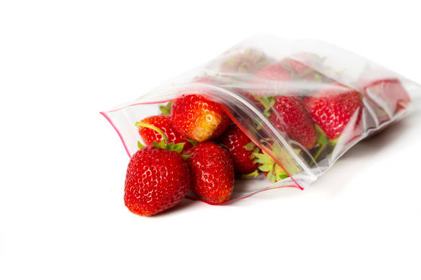 istock fresh strawberry in transparent open plastic bag with lock isolated on white. 1150763976