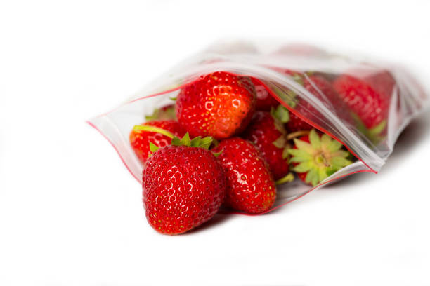 istock fresh strawberry in transparent open plastic bag with lock isolated on white. 1150763986
