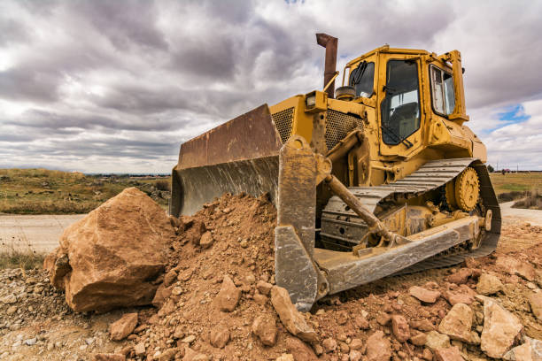 istock Excavator moving earth on construction works of a highway 1150766473