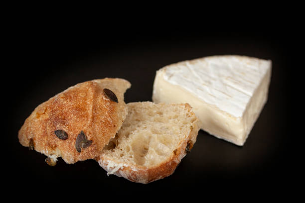 istock French brie cheese and a home baked bun on black background 1150766544