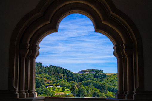 View of the mountain and forest in Vianden, Luxembourg, from an arch inside the Vianden Castle.