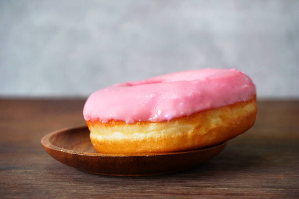 istock Sideview Donut with strawberry cream on the table 1150767251