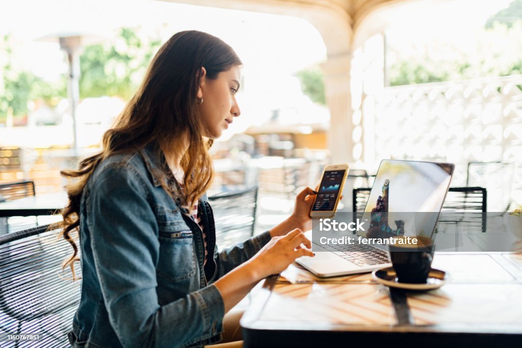 Business on the go Millennials woman working in coffeeshop Investment Stock Photo