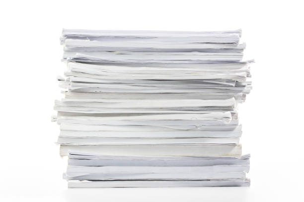 close-up of papers stack isolated on a white background - stack paper document heap imagens e fotografias de stock