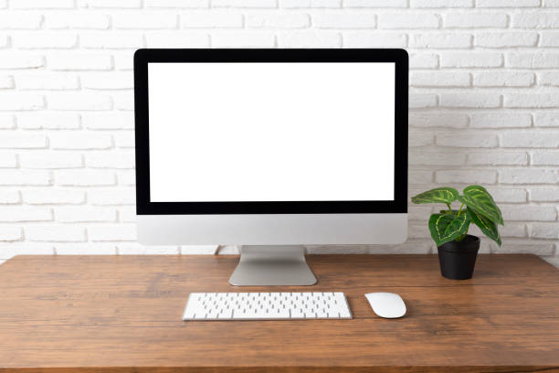 istock workspace with computer with blank white screen, and office supplies on a wooden desk 1150768355