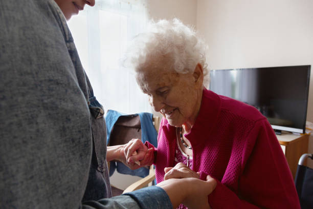 istock Senior adult getting support from caregiver 1150769341