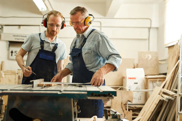 istock Carpenters Cutting Wood 1150770124