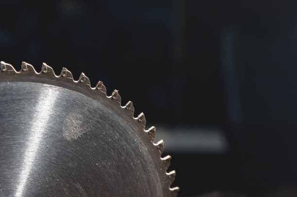 istock A closeup of a circular saw blade on a dark blue background. 1150772149
