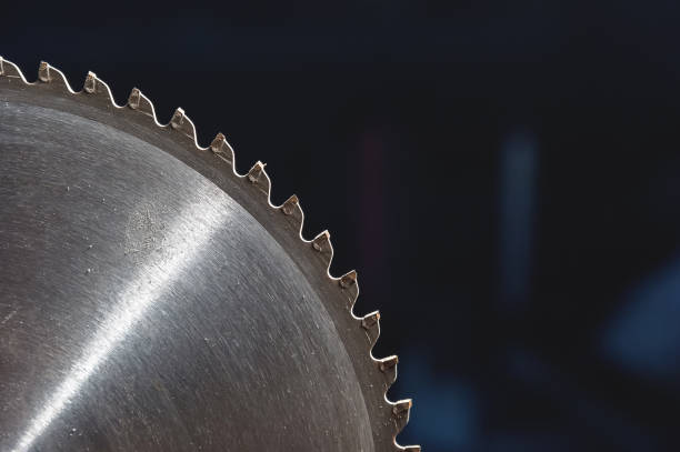 istock A closeup of a circular saw blade on a dark blue background. 1150772155