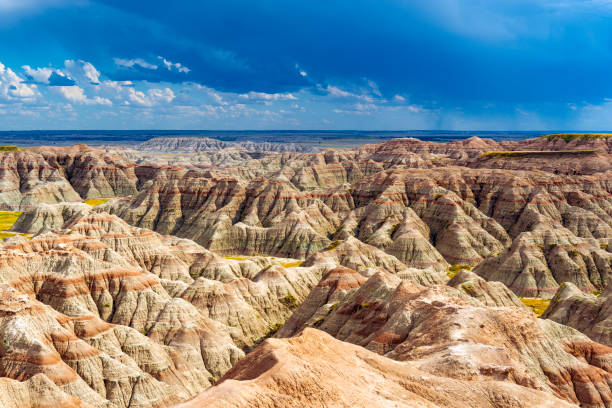 Thunderstorm in Badlands National Park, South Dakota A thunderstorm inside Badlands national park with the rock formations illuminated by sunlight near Rapid City, South Dakota, USA. badlands stock pictures, royalty-free photos & images