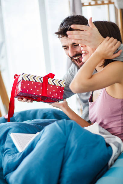 istock Man surprising his girlfriend in the morning 1150776387