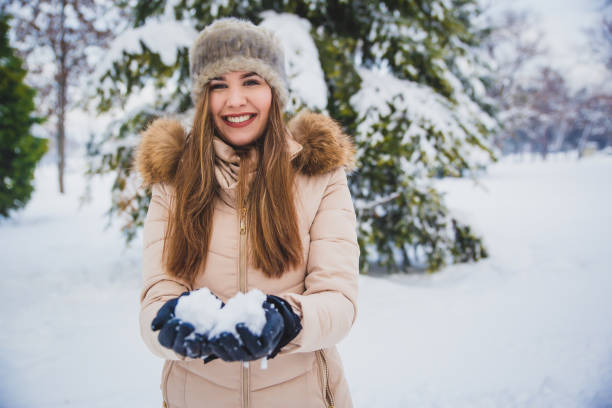 istock Woman playing with snow in the winter 1150776822