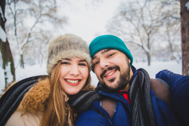 istock Happy couple enjoy in winter park 1150776908