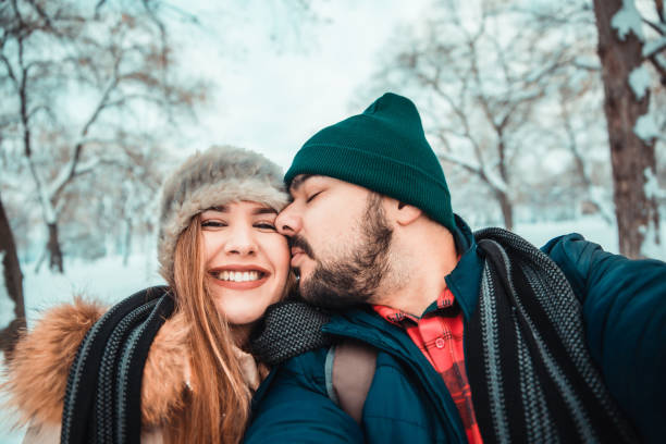 istock Happy couple enjoy in winter park 1150776970