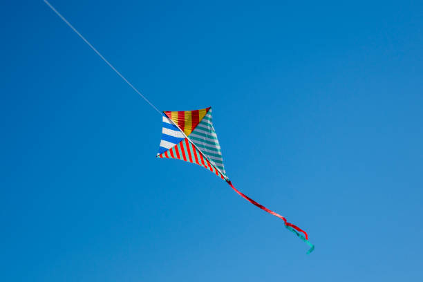 istock Colorful kite flying with waving red bow 1150778086