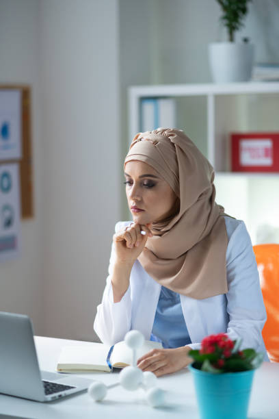 istock Female chemist wearing headscarf feeling overloaded with work 1150778392