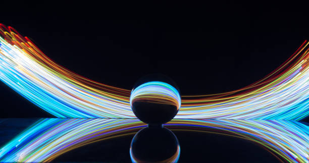 istock Light painting with crystal ball using led Christmas colorful lights and light reflection on glass with selective focus 1150779203