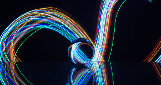 istock Light painting with crystal ball using led Christmas colorful lights and light reflection on glass with selective focus 1150779378