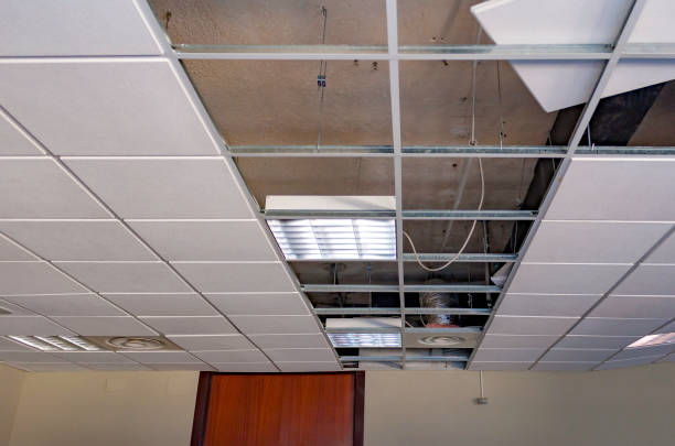 istock repairing board ceiling with gypsum. In the classroom 1150780108