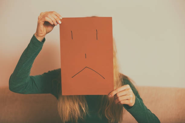 istock Depressed woman with sad face on paper 1150780326