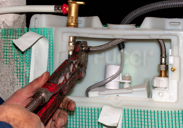 istock Workers connect the water pipes to the toilet flush box 1150781027