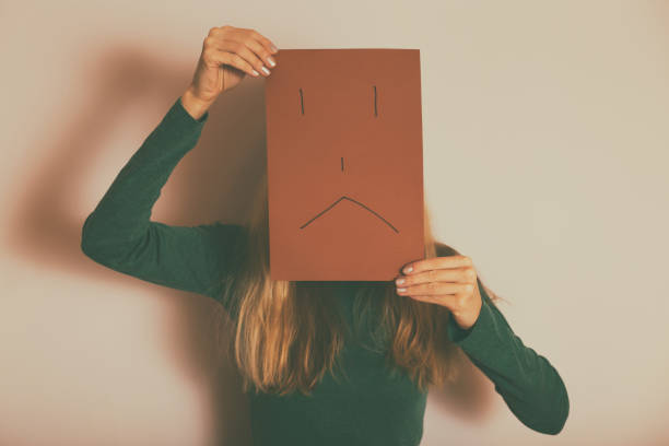 istock Depressed woman with sad face on paper 1150781572