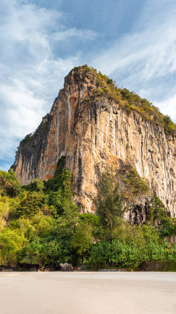 istock Large orange limestone cliff on Railay beach 1150781615