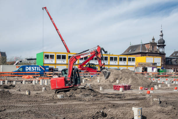 Driebergen: Construction site at the railway station in Driebergen, province Utrecht, with crane and worker welding steel.
