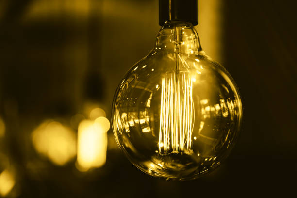 istock Huge light bulb toned in golden trend color 1150785320