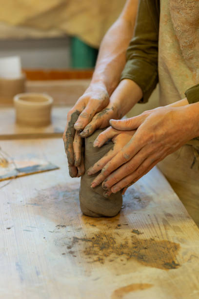 istock Ardent young couple having romantic masterclass in pottery workshop 1150786301