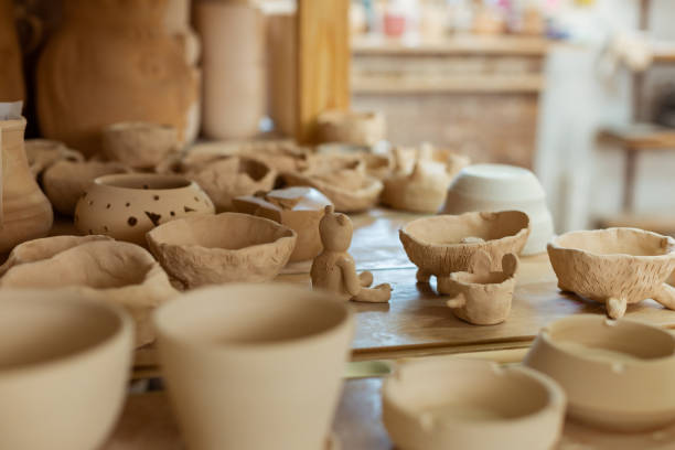 istock Bunch of fresh unprocessed clay pots placed on a working surface 1150786337