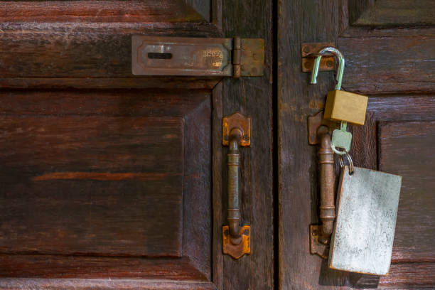 istock Old rusty and key locks on wooden door 1150786511