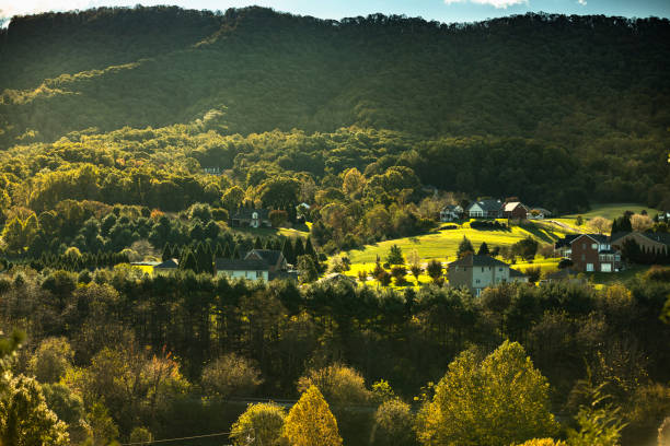 Small town in the Blue Ridge Mountains scenic vista view Tree covered hills and cottages of the Blue Ridge Mountains in North Carolina USA shenandoah national park photos stock pictures, royalty-free photos & images