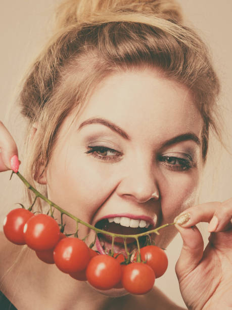 istock Woman holding fresh cherry tomatoes 1150786886