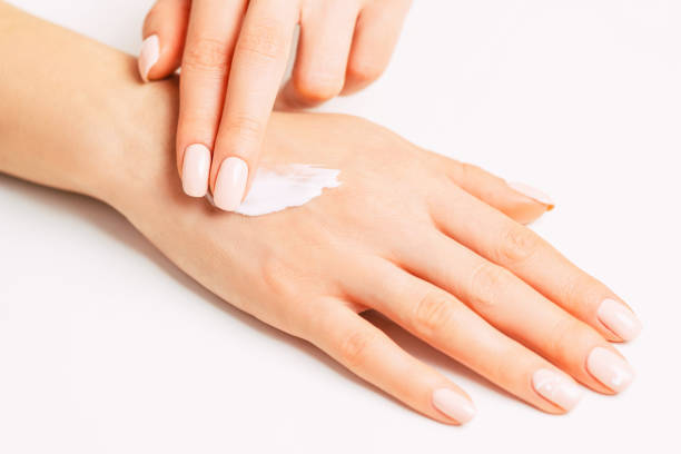 istock Woman’s hands applying moisturizing skincare cream. 1150787935