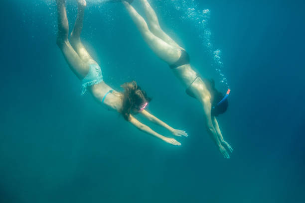 istock Mother and daughter snorkeling together 1150787985