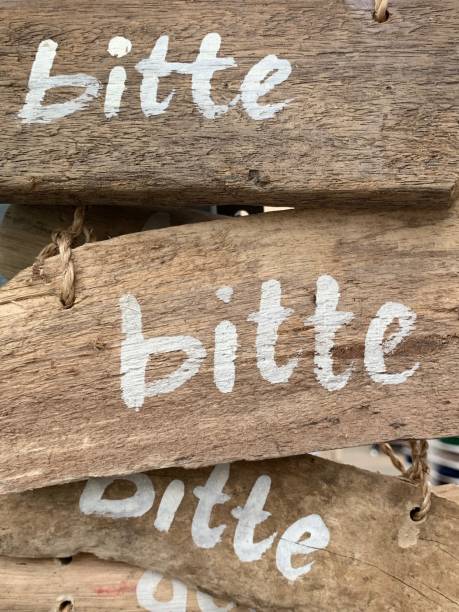 istock German word bitte (please) on wooden planks 1150788497