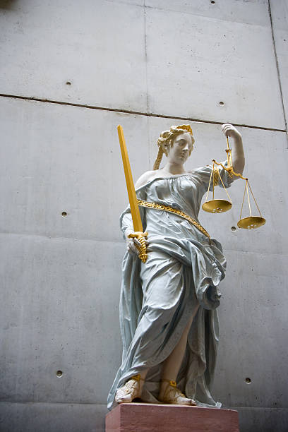 istock Fragile lady Justice against concrete wall 115078853