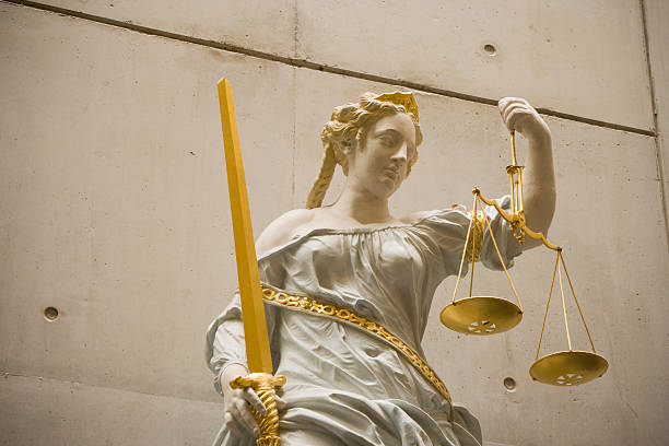 Lady Justice holding gold plated sword and scales
