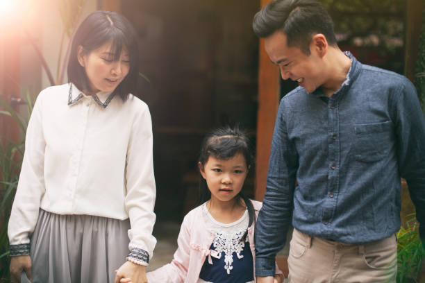 istock Asian Family Portrait in Front Yard 1150793282