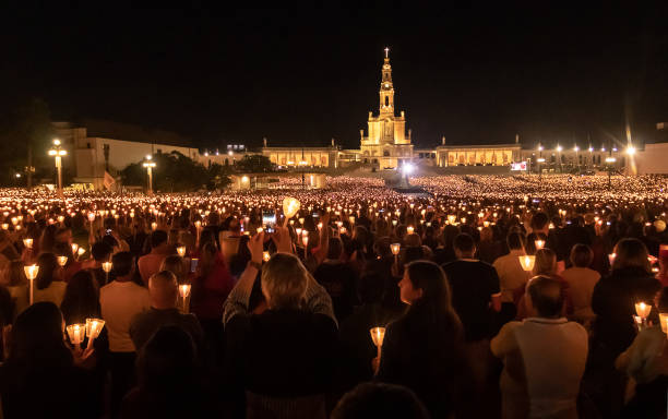 Shrine of Fatima in Portugal, procession of the candles. Fatima, Portugal - May 12, 2019: Shrine of Fatima in Portugal, procession of the candles with the Basilica of Our Lady of the Rosary of Fatima in the background. shrine stock pictures, royalty-free photos & images
