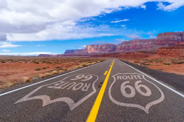 Route 66 sign on a scenic road to a mountain range in Arizona