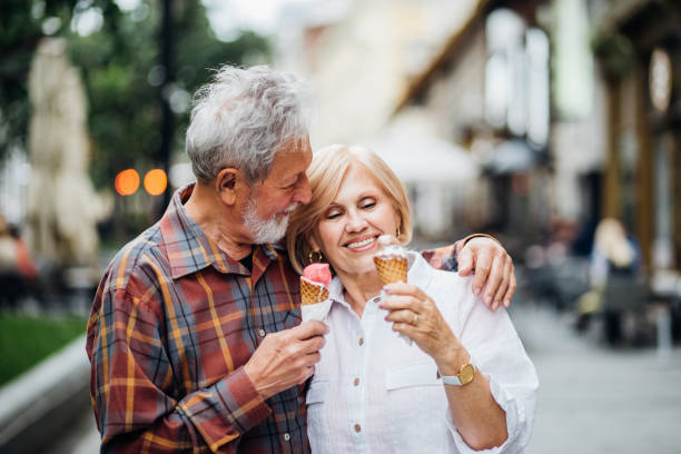 istock Mature couple hugging and eating ice-cream 1150794637