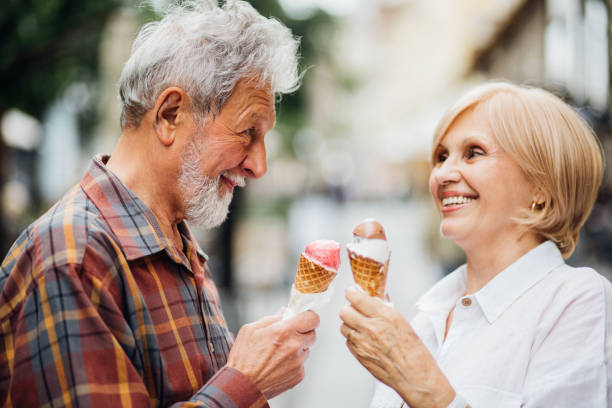 istock Man and woman holding ice creams 1150794700