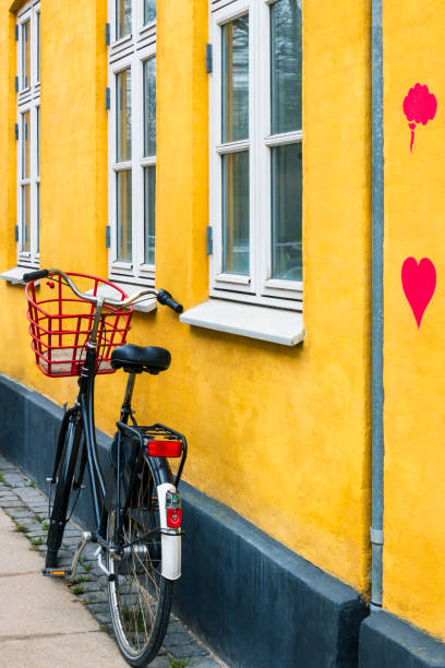 Bicycle with heart on yellow house wall