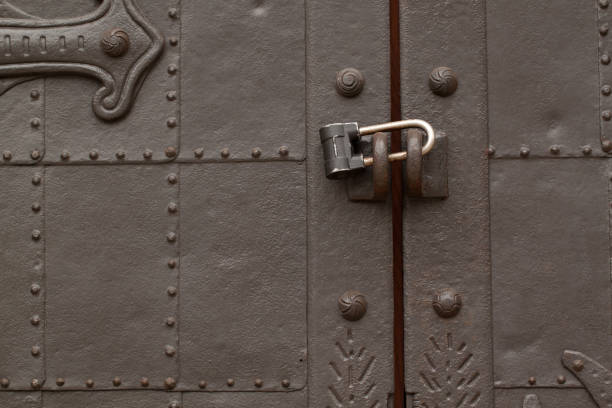 Forged antique metall door beautiful antique metal door with padlock, very sturdy and reliable riveting stock pictures, royalty-free photos & images