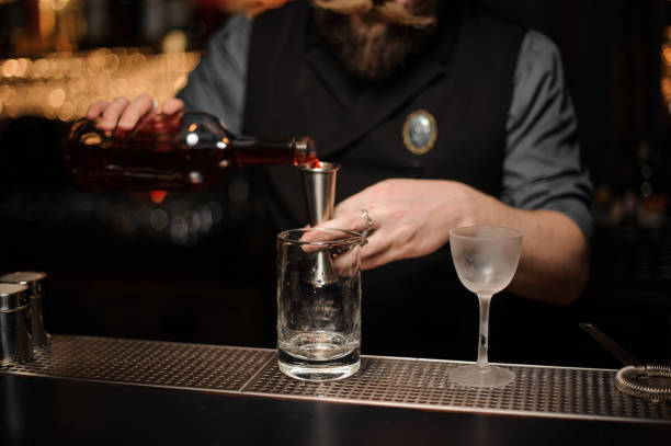 istock Male bartender pours alcohol drink with jigger 1150796678
