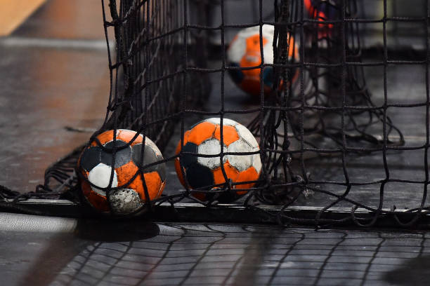 Handball ball and the net from the goal Handball ball and the net from the goal team handball stock pictures, royalty-free photos & images